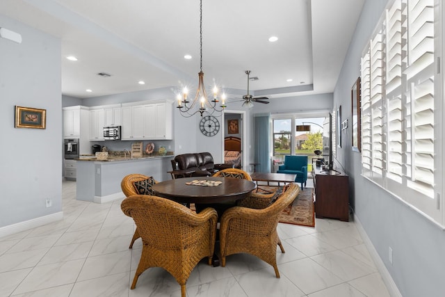 dining room with ceiling fan with notable chandelier