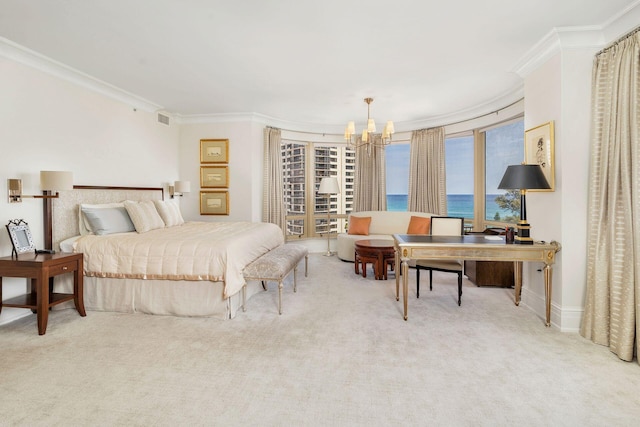 bedroom featuring a chandelier, a water view, ornamental molding, and light colored carpet