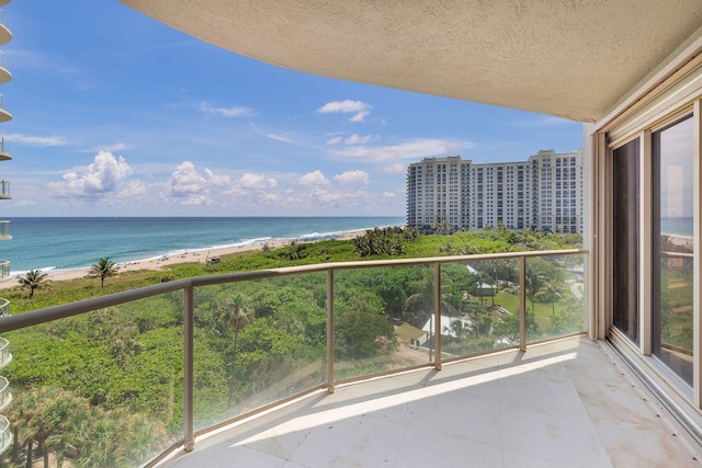 balcony with a view of the beach and a water view