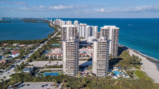 bird's eye view featuring a water view and a beach view