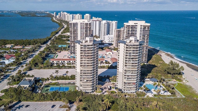 birds eye view of property with a water view and a view of the beach