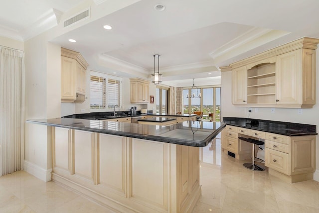 kitchen with pendant lighting, a kitchen breakfast bar, sink, crown molding, and kitchen peninsula