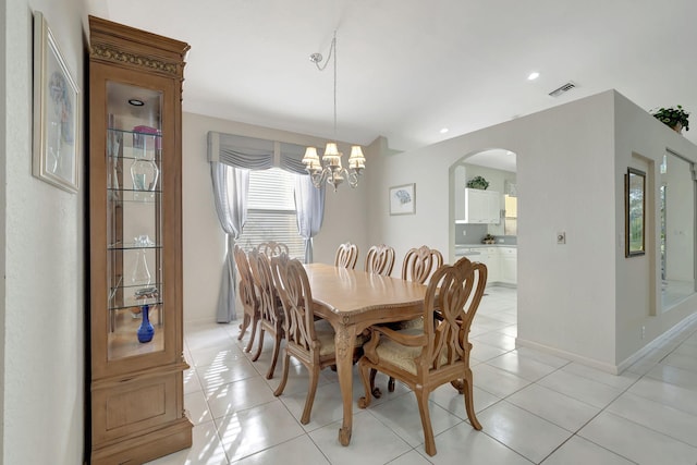 tiled dining space featuring a chandelier