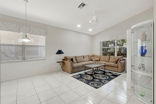 living room featuring lofted ceiling and light tile patterned flooring