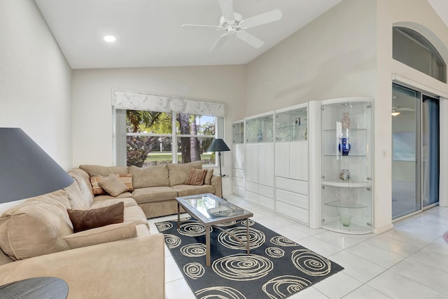 tiled living room with vaulted ceiling and ceiling fan