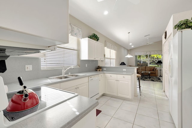 kitchen with white cabinets, kitchen peninsula, white appliances, and vaulted ceiling