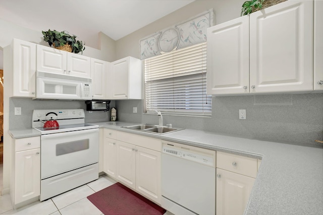 kitchen with backsplash, white cabinetry, light tile patterned floors, sink, and white appliances