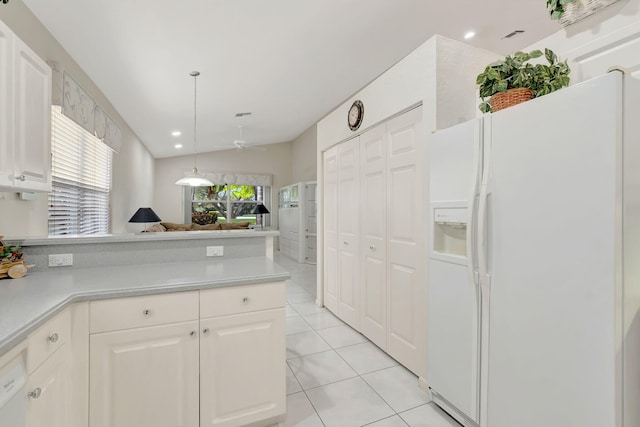 kitchen featuring light tile patterned flooring, white cabinetry, and white refrigerator with ice dispenser