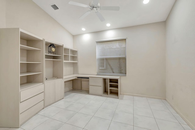 unfurnished office with built in desk, ceiling fan, light tile patterned floors, and lofted ceiling