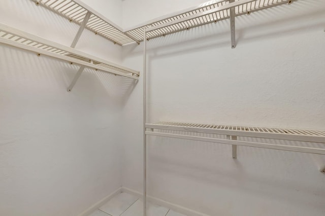 spacious closet featuring tile patterned flooring