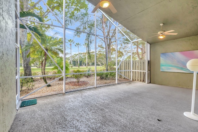 unfurnished sunroom with ceiling fan