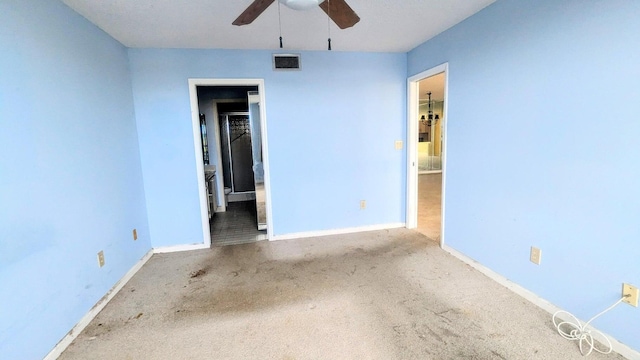 unfurnished room with ceiling fan and light colored carpet