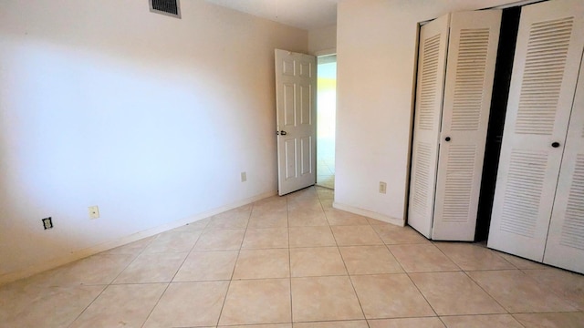 unfurnished bedroom with light tile patterned flooring