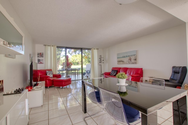 tiled dining area featuring floor to ceiling windows and a textured ceiling