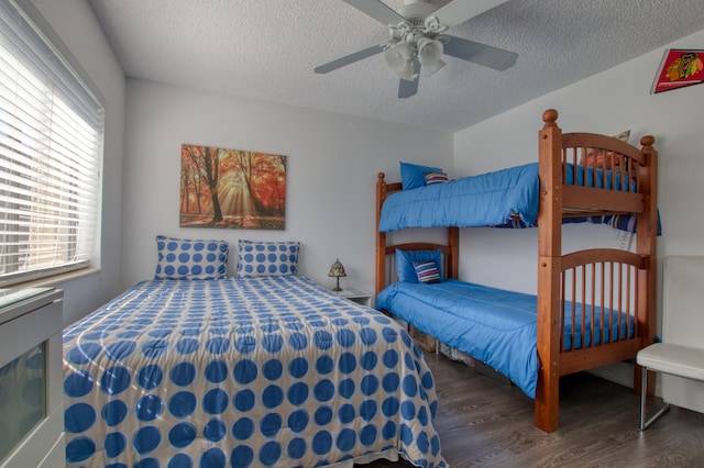 bedroom featuring a textured ceiling, ceiling fan, and dark hardwood / wood-style flooring