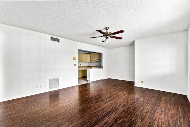 unfurnished living room with dark hardwood / wood-style floors, ceiling fan, and a textured ceiling