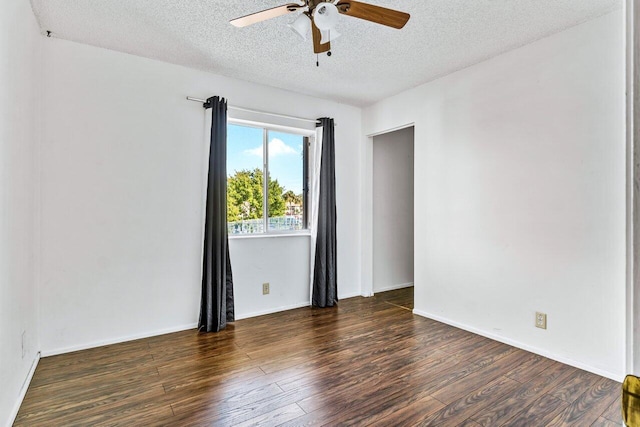 spare room featuring ceiling fan, dark hardwood / wood-style flooring, and a textured ceiling