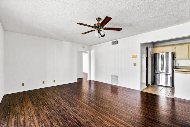 unfurnished living room with ceiling fan, wood-type flooring, and a textured ceiling