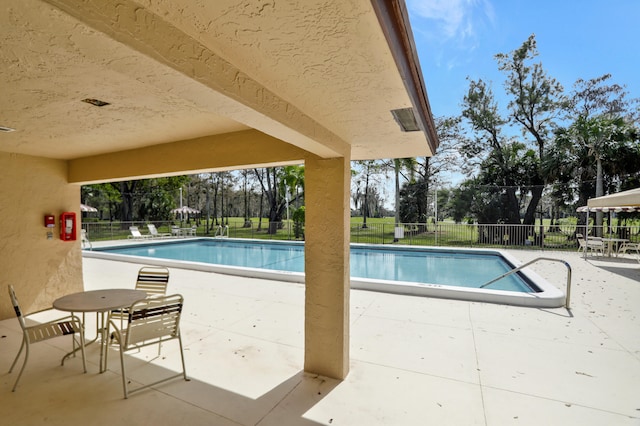 view of swimming pool with a patio area