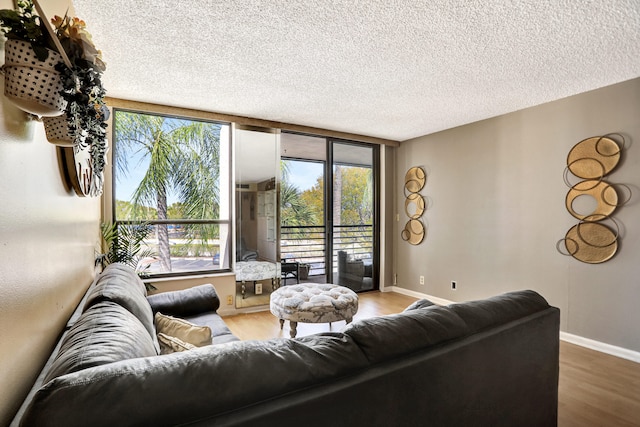 living room with a textured ceiling and light hardwood / wood-style floors