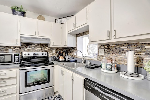 kitchen with tasteful backsplash, stainless steel appliances, white cabinetry, and sink