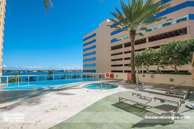 view of swimming pool with a patio area and a community hot tub