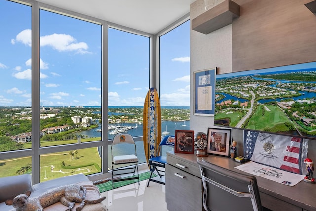 sunroom / solarium featuring a water view and a healthy amount of sunlight