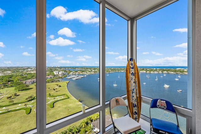 sunroom featuring plenty of natural light and a water view