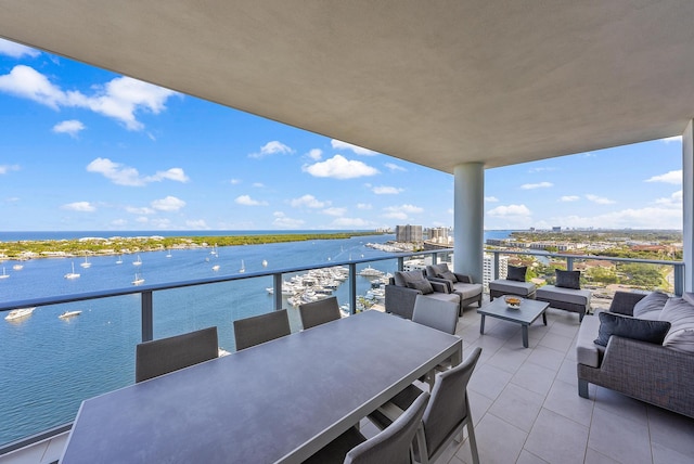 balcony with a water view and outdoor lounge area