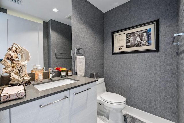 bathroom featuring toilet, tile floors, and vanity