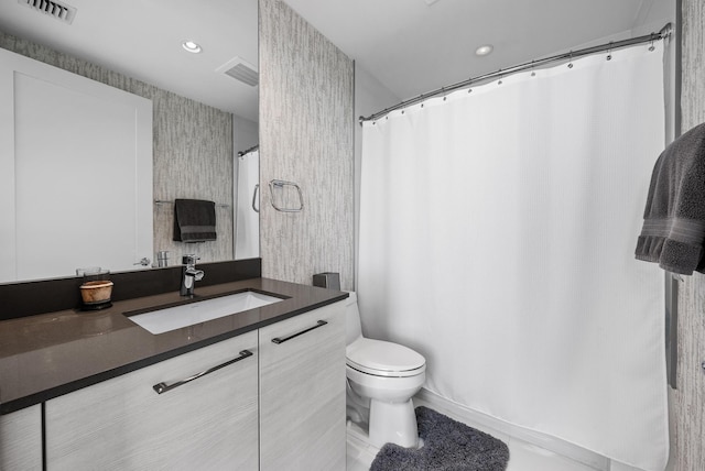 bathroom featuring toilet and large vanity