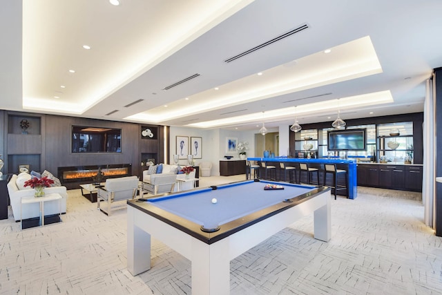 game room featuring a raised ceiling and billiards