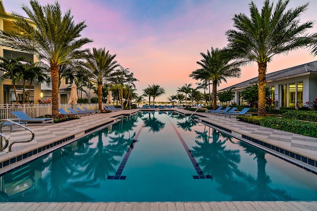 pool at dusk with a patio