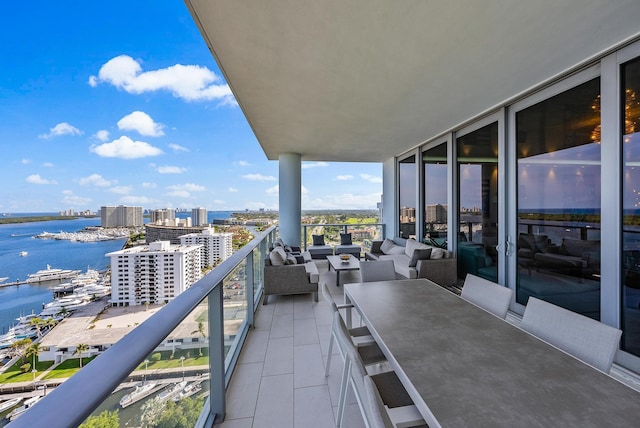 balcony with an outdoor hangout area and a water view