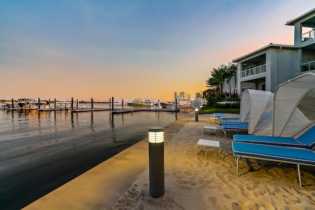 view of dock featuring a balcony and a water view