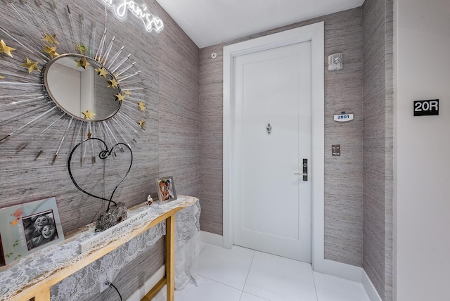 doorway to outside with light tile floors and tile walls