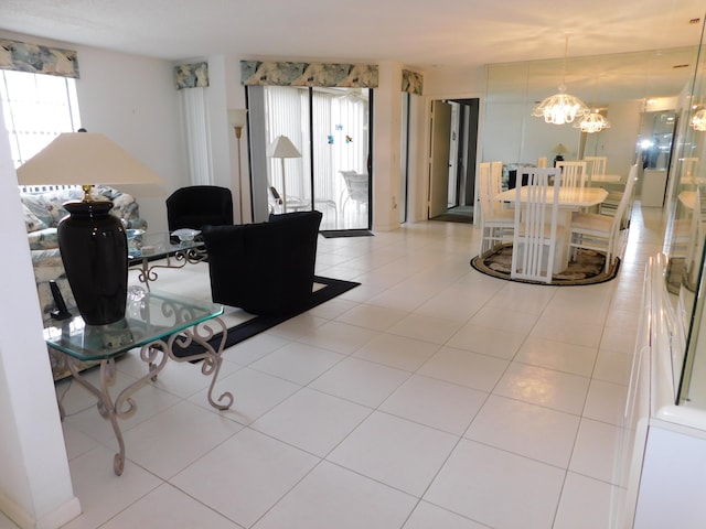 living room featuring light tile flooring and a notable chandelier