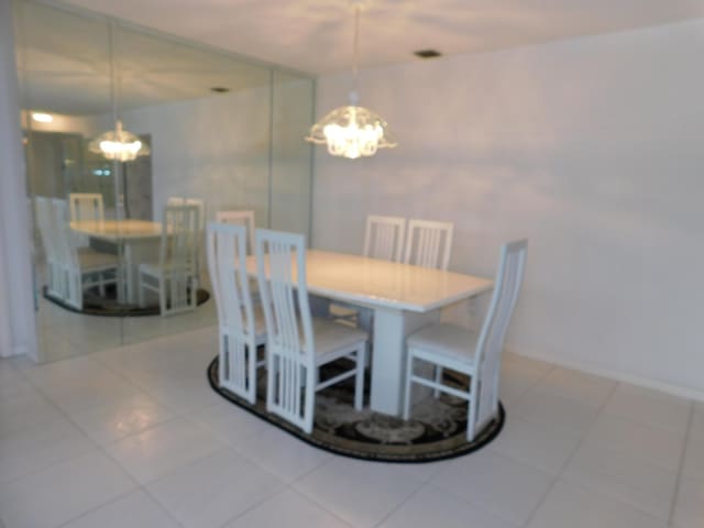 dining room with light tile flooring and a notable chandelier