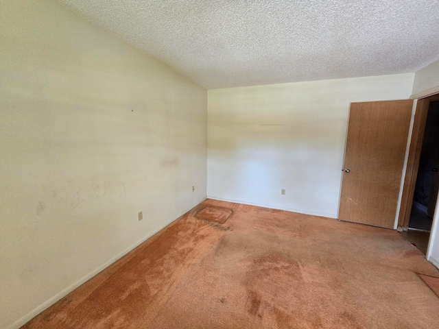 empty room featuring carpet floors and a textured ceiling