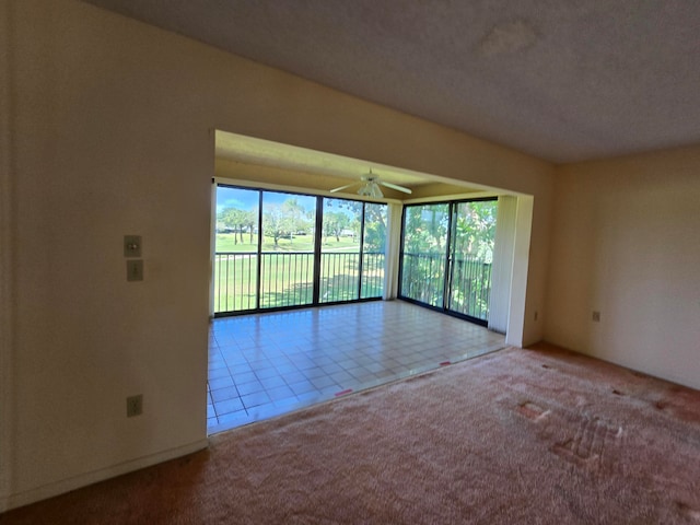 unfurnished room featuring light tile flooring and ceiling fan