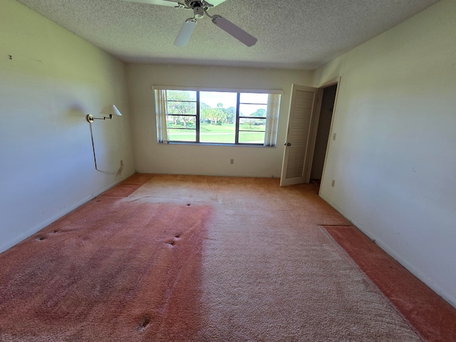 empty room featuring light carpet, a textured ceiling, and ceiling fan