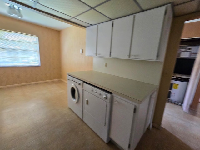 kitchen featuring white cabinets, separate washer and dryer, and dishwasher