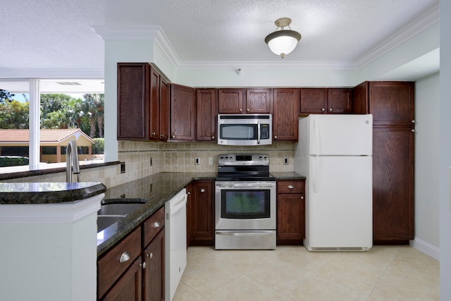 kitchen featuring appliances with stainless steel finishes, tasteful backsplash, light tile floors, and crown molding