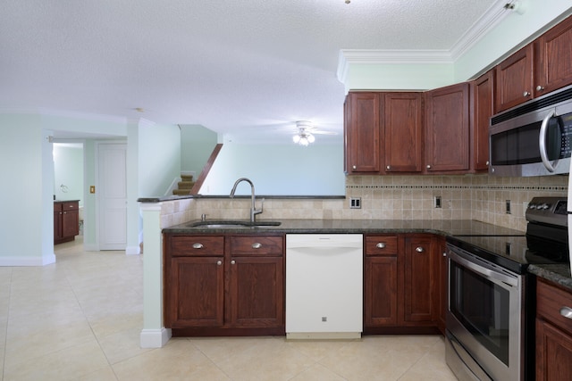 kitchen with backsplash, appliances with stainless steel finishes, light tile floors, and sink