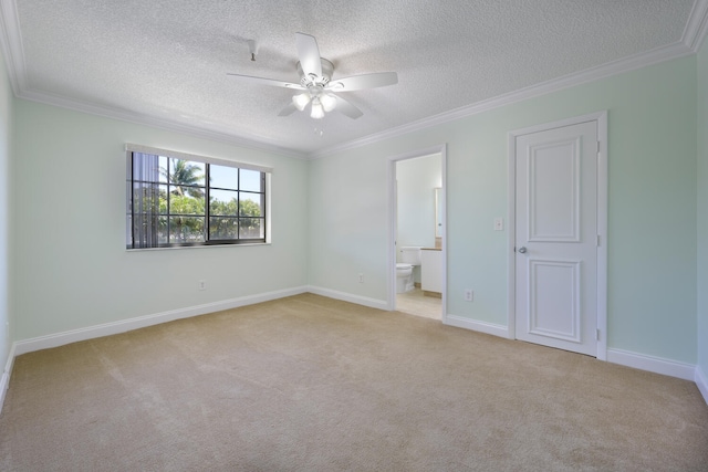 unfurnished bedroom with ceiling fan, a textured ceiling, light carpet, connected bathroom, and crown molding