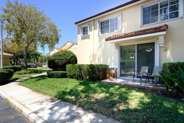 mediterranean / spanish-style home with a front lawn