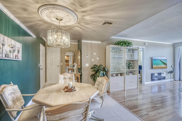336 Golfview Rd Unit 1011, North Palm Beach, FL 33408 - tiled dining room featuring arched walkways, ornamental molding, a chandelier, and baseboards