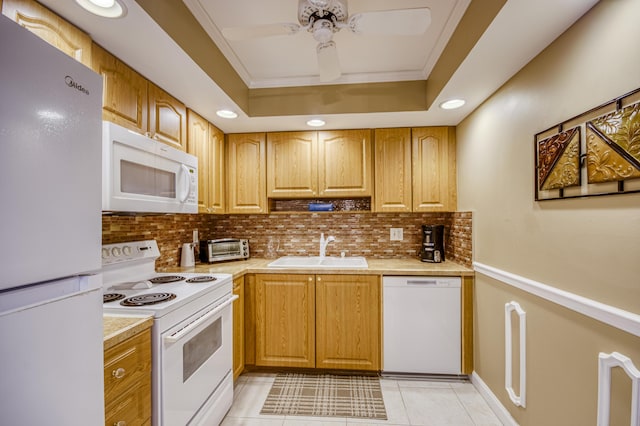 336 Golfview Rd Unit 1011, North Palm Beach, FL 33408 - kitchen with white appliances, a sink, decorative backsplash, a raised ceiling, and light countertops