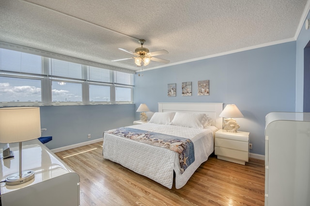 336 Golfview Rd Unit 1011, North Palm Beach, FL 33408 - bedroom featuring a textured ceiling, baseboards, crown molding, light wood-type flooring, and a ceiling fan