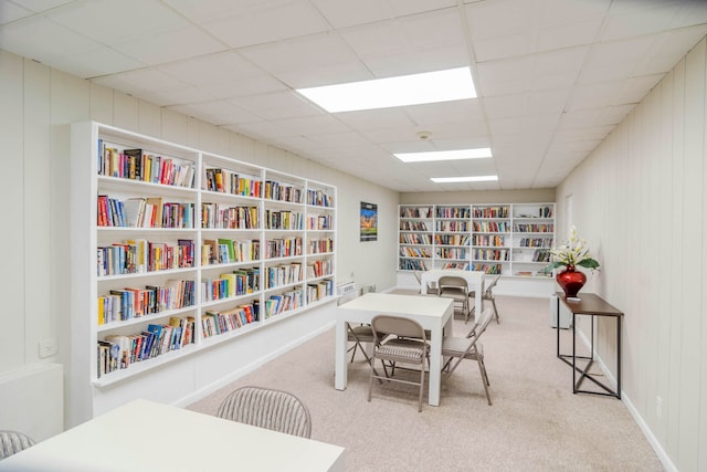 home office with a paneled ceiling and light colored carpet